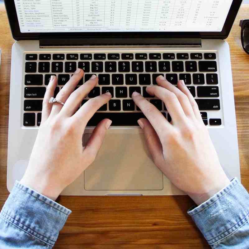 Content creation and website copywriting. Hands typing and writing.
