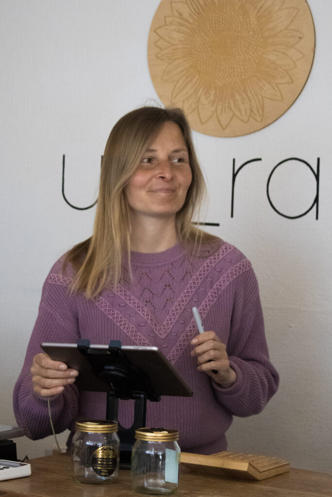 Writer, educator & environmentalist Hannah Pearce. Writing behind a desk of environmental brand