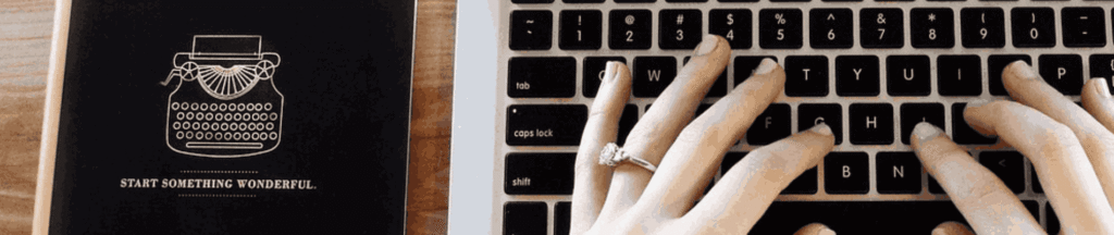 Hand typing on laptop.